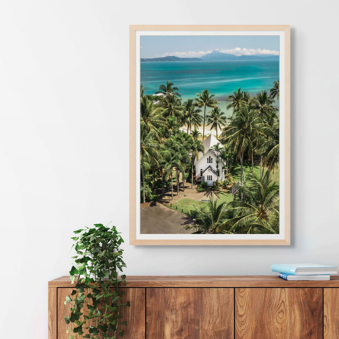 Give Me a Reason to Stay Here – Aerial view of St Mary’s, Port Douglas, with palm trees and a stunning green and blue seascape | Framed Paper Print