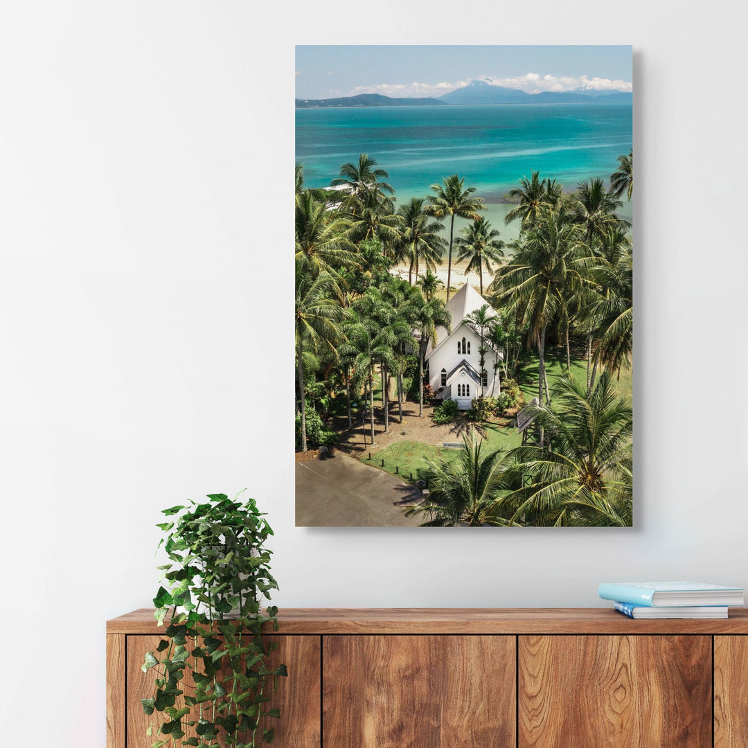 Give Me a Reason to Stay Here – Aerial view of St Mary’s, Port Douglas, with palm trees and a stunning green and blue seascape | Stretched Canvas Print
