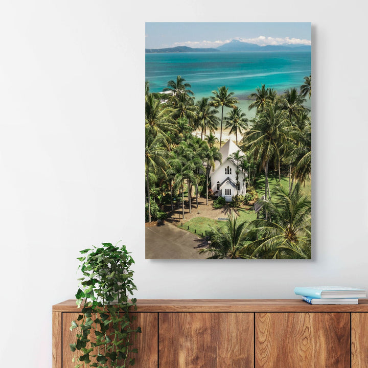 Give Me a Reason to Stay Here – Aerial view of St Mary’s, Port Douglas, with palm trees and a stunning green and blue seascape | Stretched Canvas Print