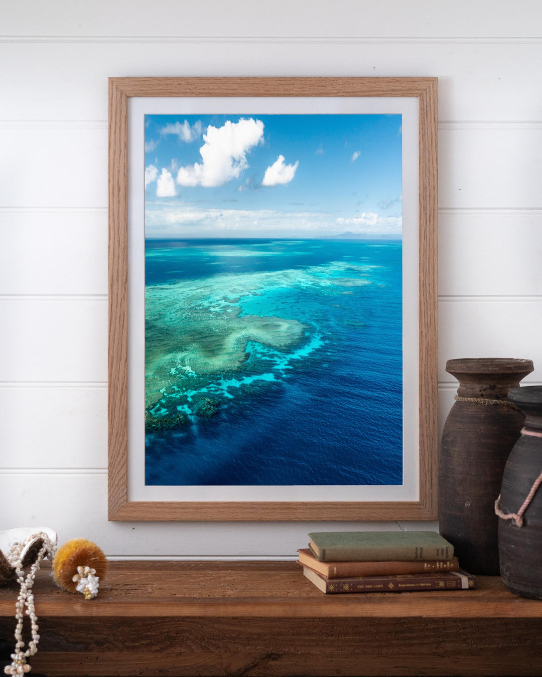 Aerial photography of a vibrant coral reef in turquoise water, titled Always Take The Weather With You by Rudder Reef.