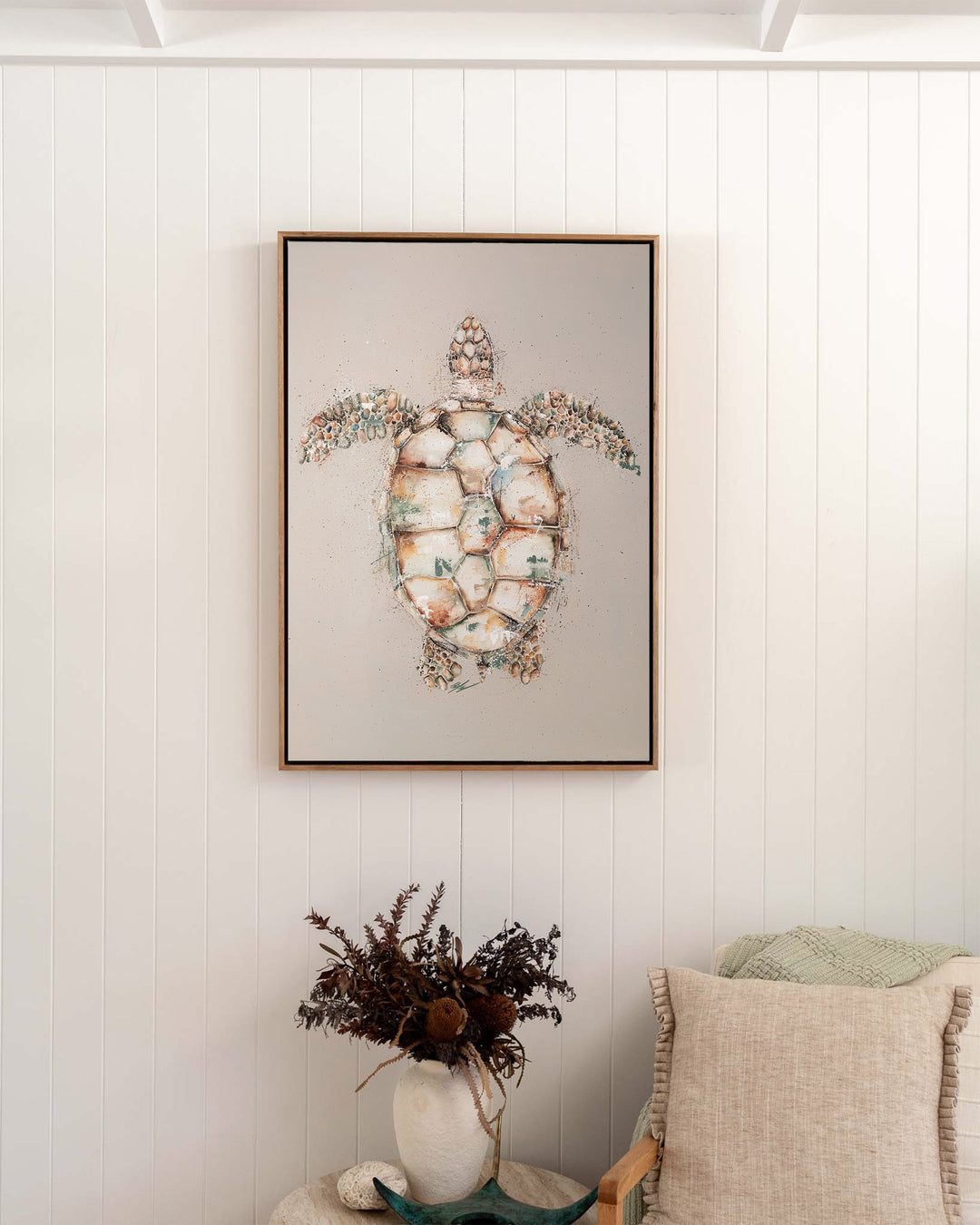 Green sea turtle fine art print by Stephanie Elizabeth, framed canvas in an oak frame in a bedroom