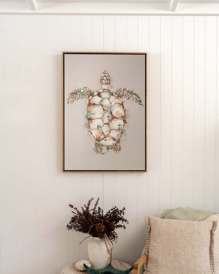 Green sea turtle fine art print by Stephanie Elizabeth, framed canvas in an oak frame in a bedroom