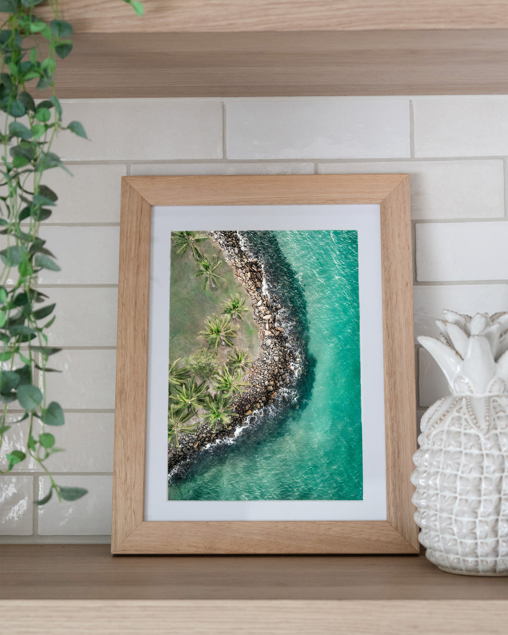 Hammocks and Hangouts – Rex Smeal, Port Douglas, Aerial Photography by David Lloyd, framed paper print in oak frame, styled in a kitchen shelf setting