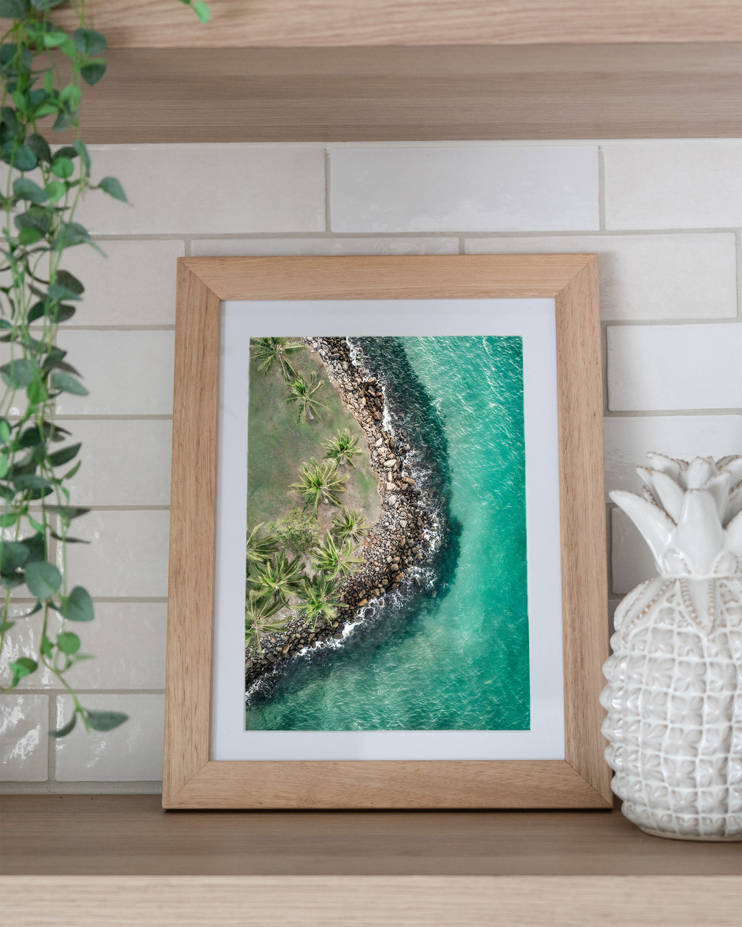 Hammocks and Hangouts – Rex Smeal, Port Douglas, Aerial Photography by David Lloyd, framed paper print in oak frame, styled in a kitchen shelf setting