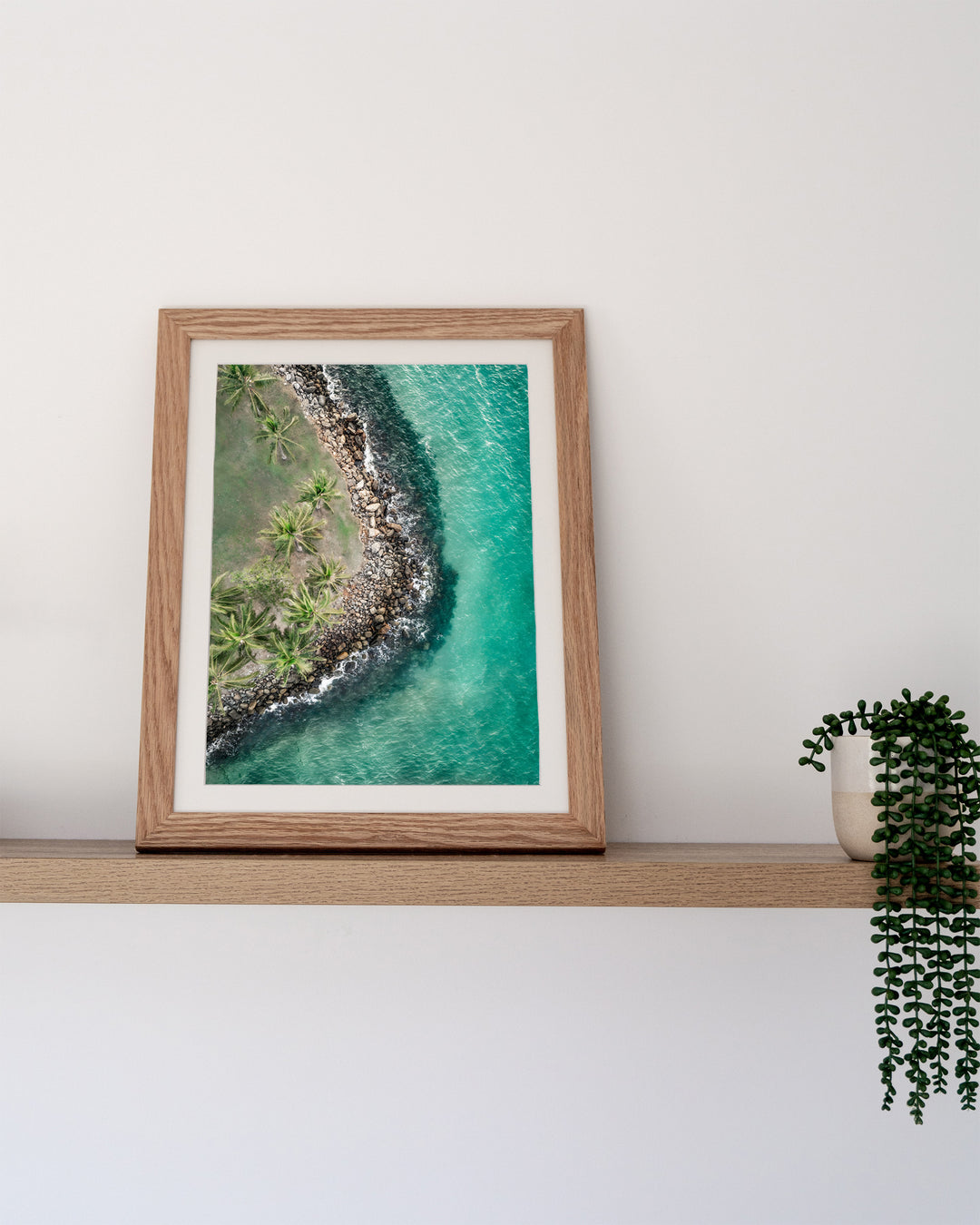 Hammocks and Hangouts – Rex Smeal, Port Douglas, Aerial Photography by David Lloyd, framed paper print in oak frame, styled in a timber shelf setting