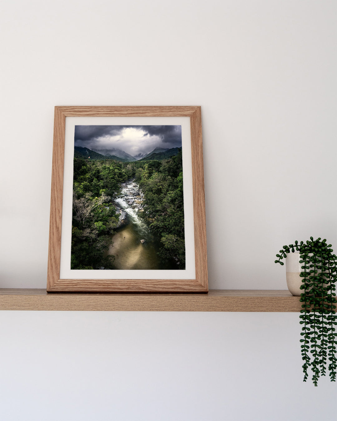 Hazy Habits – Mossman Gorge, Aerial Photography by David Lloyd, framed paper print in oak frame, styled in a timber shelf setting