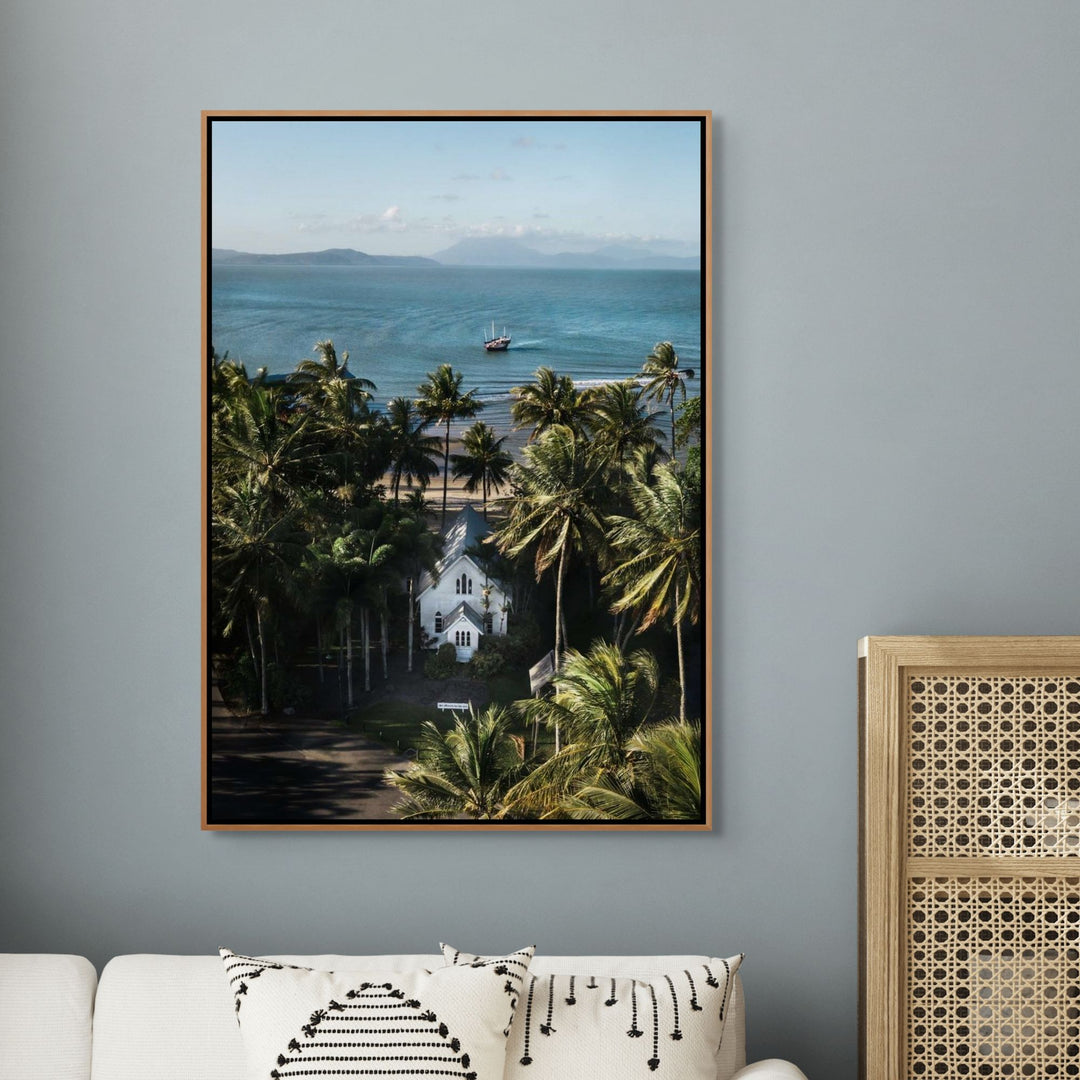 Heading Home – Aerial photograph of St Mary’s Chapel in Port Douglas with palms, ocean views and Shaolin figure in frame | Shadow Box Canvas Print