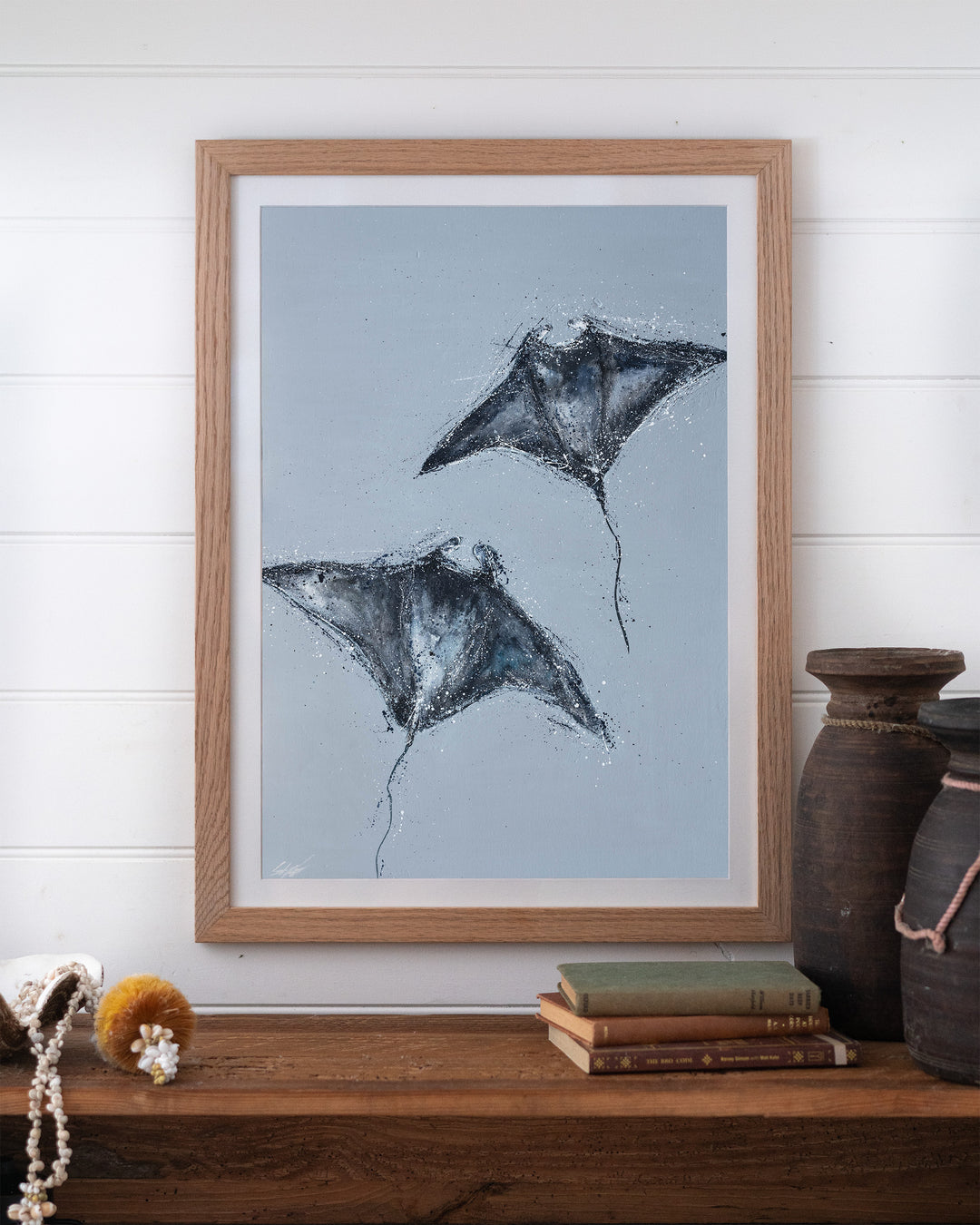 Heart Beats Slow manta rays fine art print by Stephanie Elizabeth, framed paper print in an oak frame on a shelf
