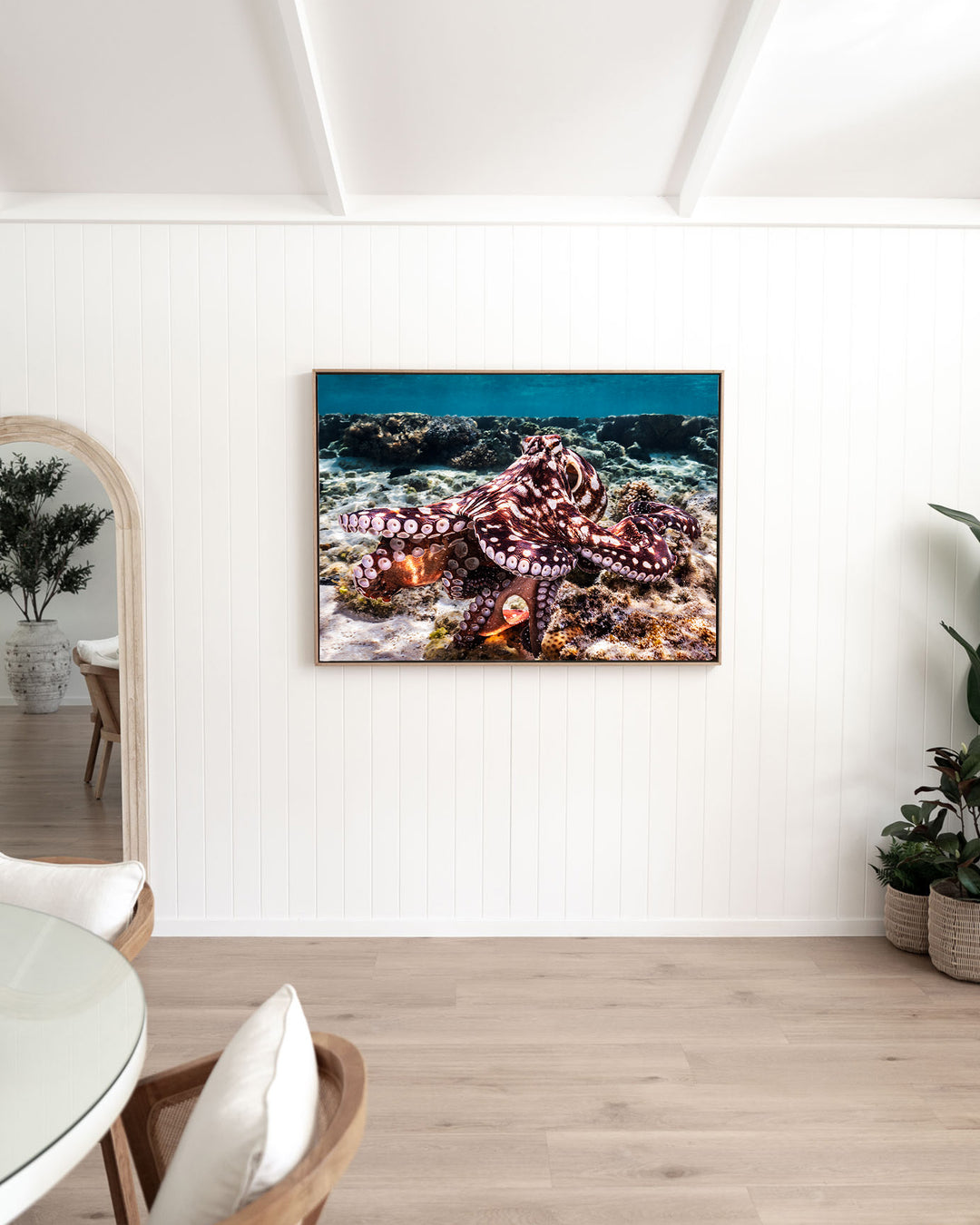 Hold On – Octopus, Underwater Photography by David Lloyd, framed canvas print in oak float frame, styled in a dining room setting