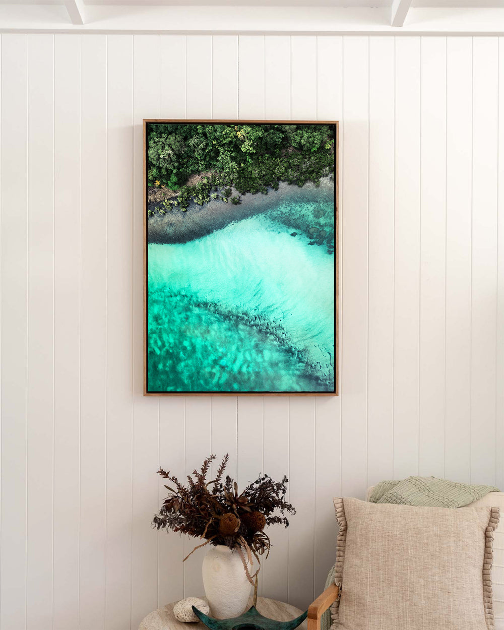 It's Only Natural – Cape Tribulation, Aerial Photography by David Lloyd, framed canvas print in oak float frame, styled in a bedroom setting