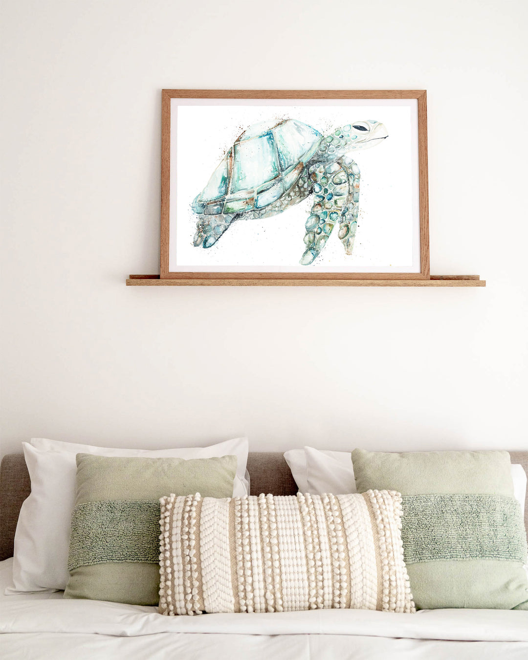 Jade sea turtle fine art print by Stephanie Elizabeth, framed paper print in an oak frame in a bedroom