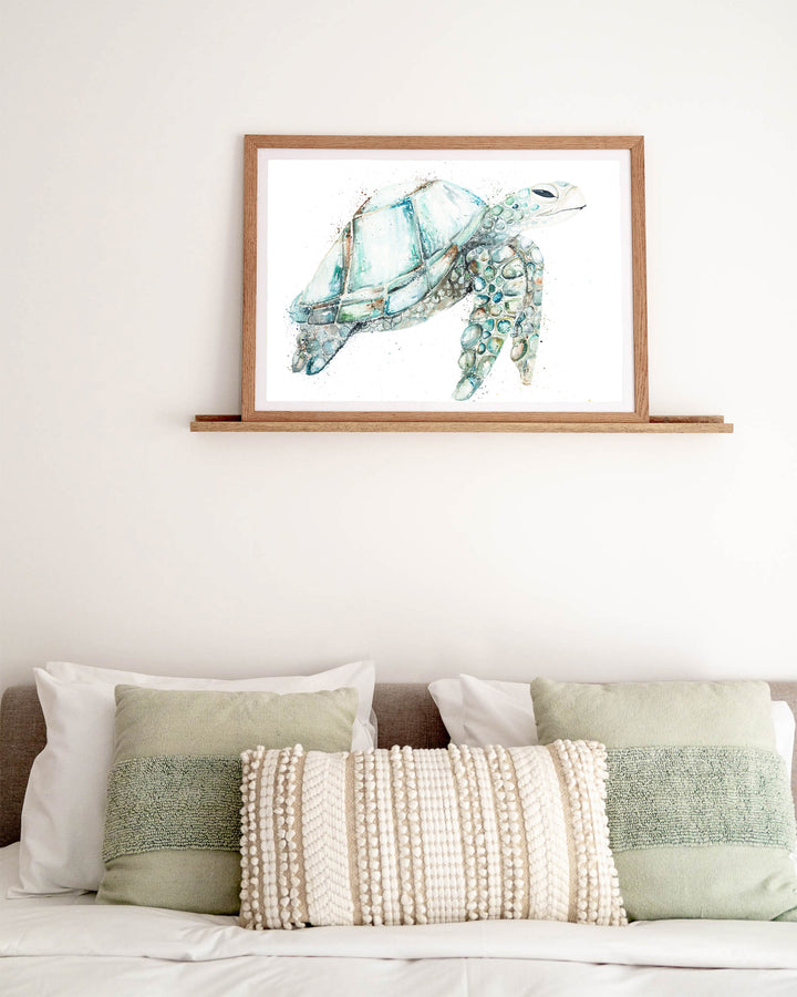 Jade sea turtle fine art print by Stephanie Elizabeth, framed paper print in an oak frame in a bedroom