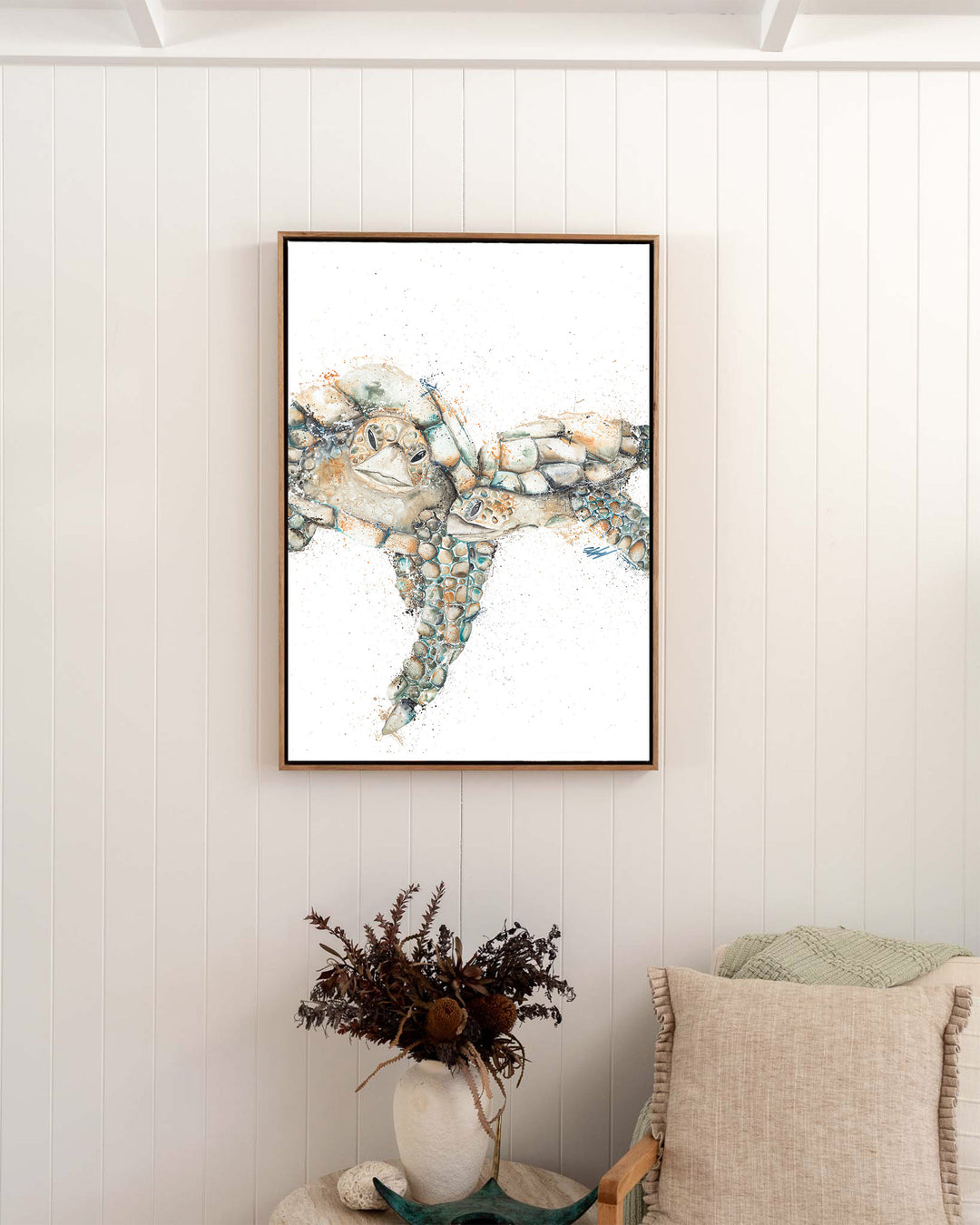 Joined at the Hip – sea turtles, framed canvas in oak float frame, styled in a bedroom