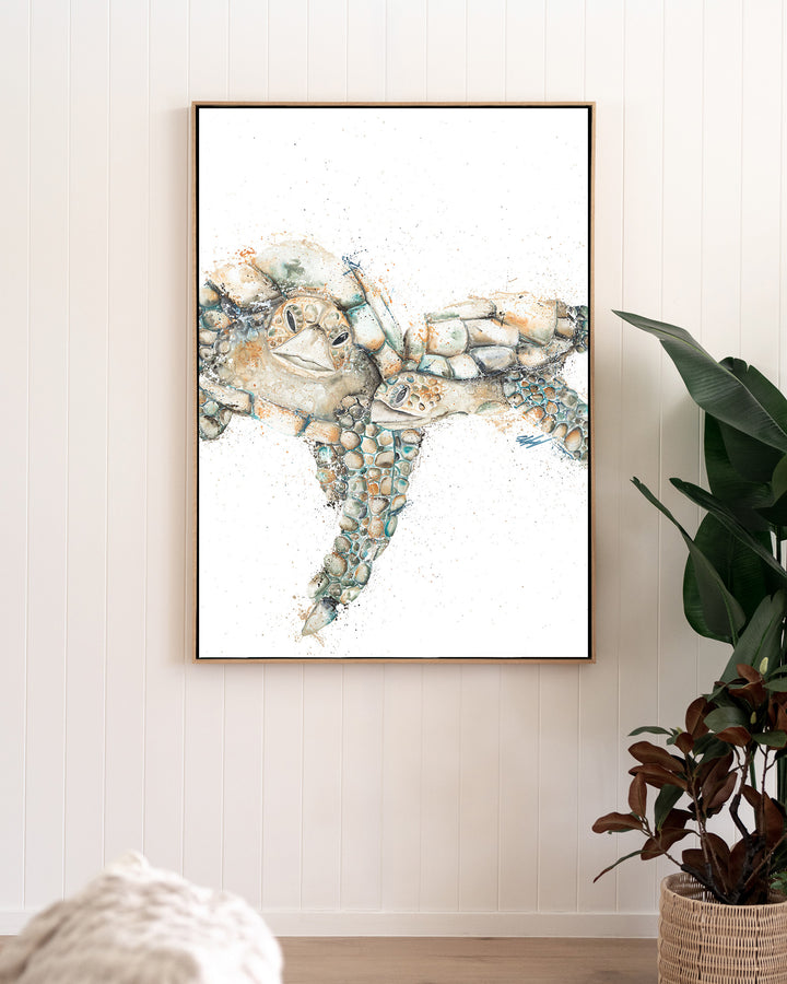 Joined at the Hip – sea turtles, framed canvas in oak float frame, styled in a living room