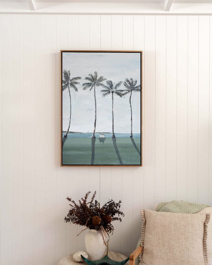 Just Us – palm trees and ocean landscape, framed canvas in oak float frame, styled in a bedroom