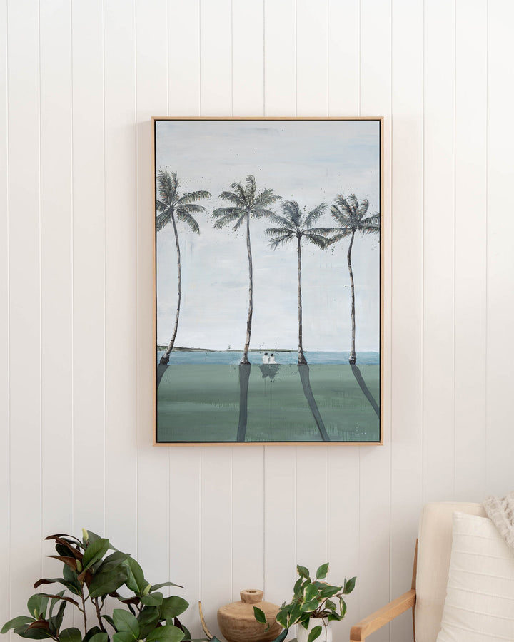 Just Us – palm trees and ocean landscape, framed canvas in oak float frame, styled in a hallway
