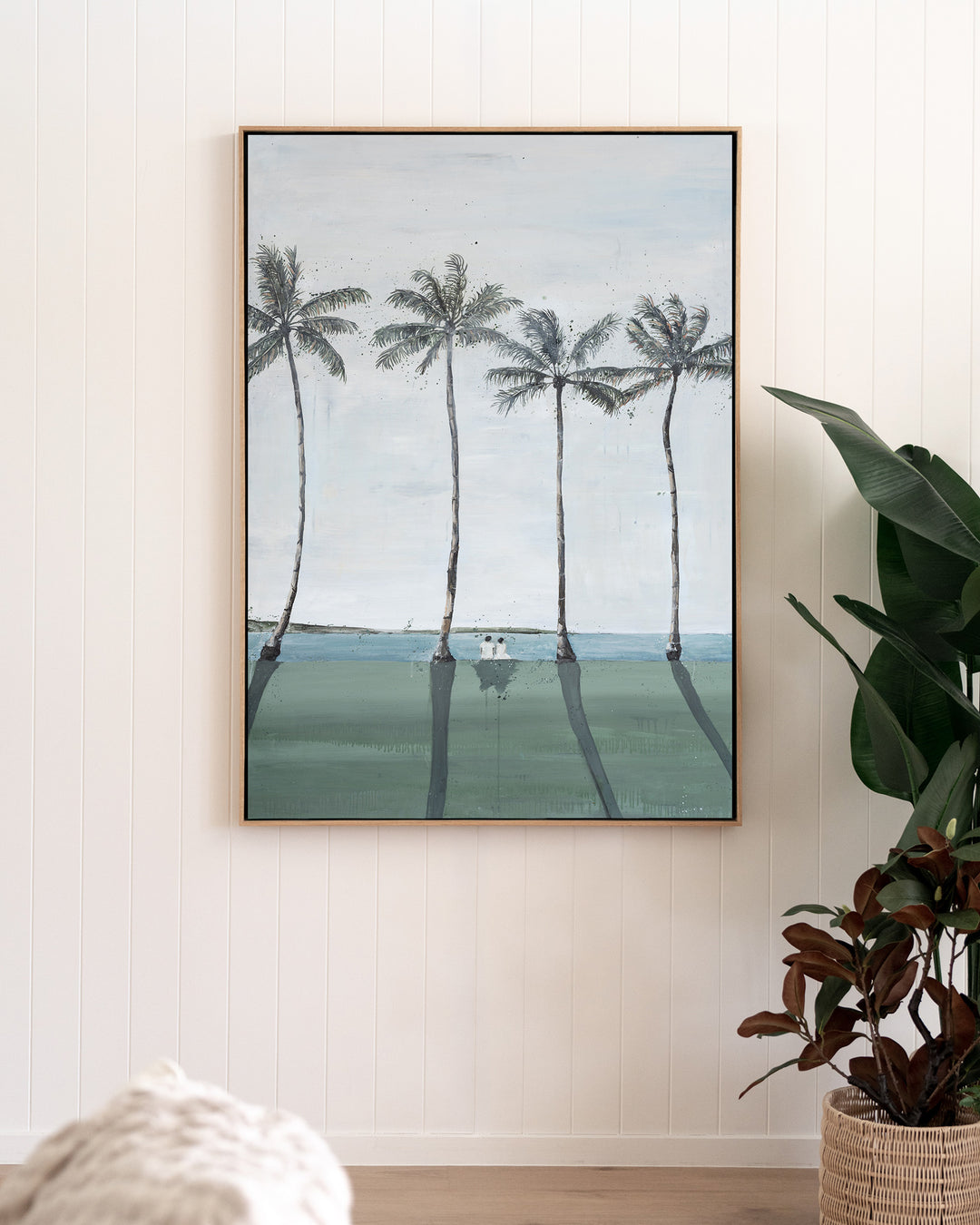 Just Us – palm trees and ocean landscape, framed canvas in oak float frame, styled in a living room