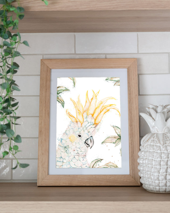 Lemon Sorbet – white cockatoo, framed paper print in oak frame, styled on a kitchen shelf