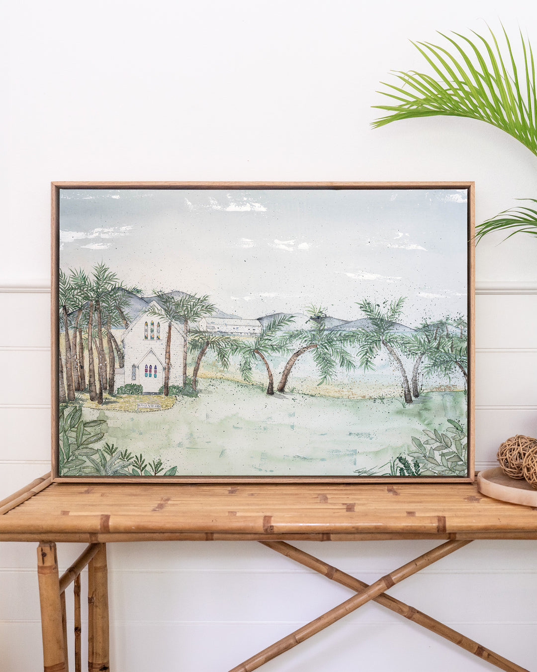 Let's Head There for Sunset – Port Douglas landscape, framed canvas in oak float frame, styled on a rattan table