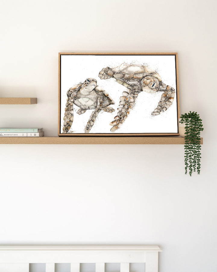 Life by Your Side green sea turtles fine art print by Stephanie Elizabeth, framed canvas in an oak frame on a shelf
