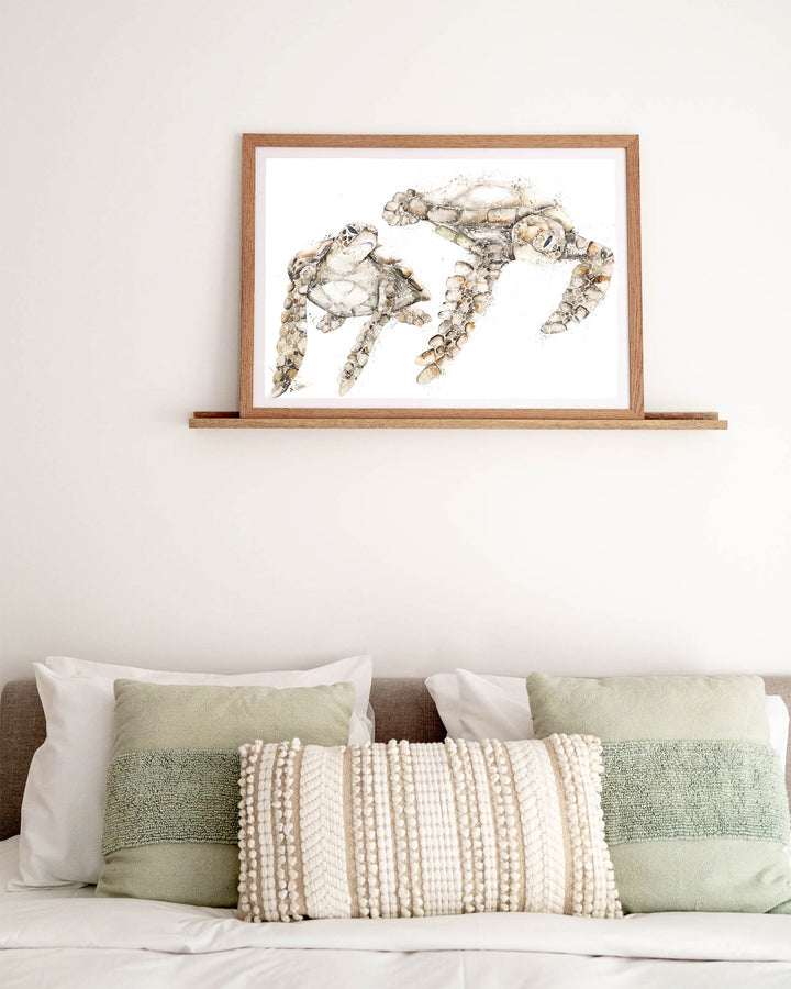 Life by Your Side green sea turtles fine art print by Stephanie Elizabeth, framed paper print in an oak frame in a bedroom