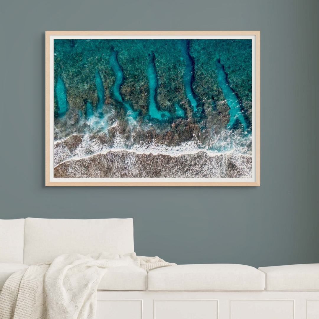 Life On The Edge – Aerial photograph of the Great Barrier Reef with waves crashing over coral formations, intricate reef patterns and turquoise waters | Framed Paper Print