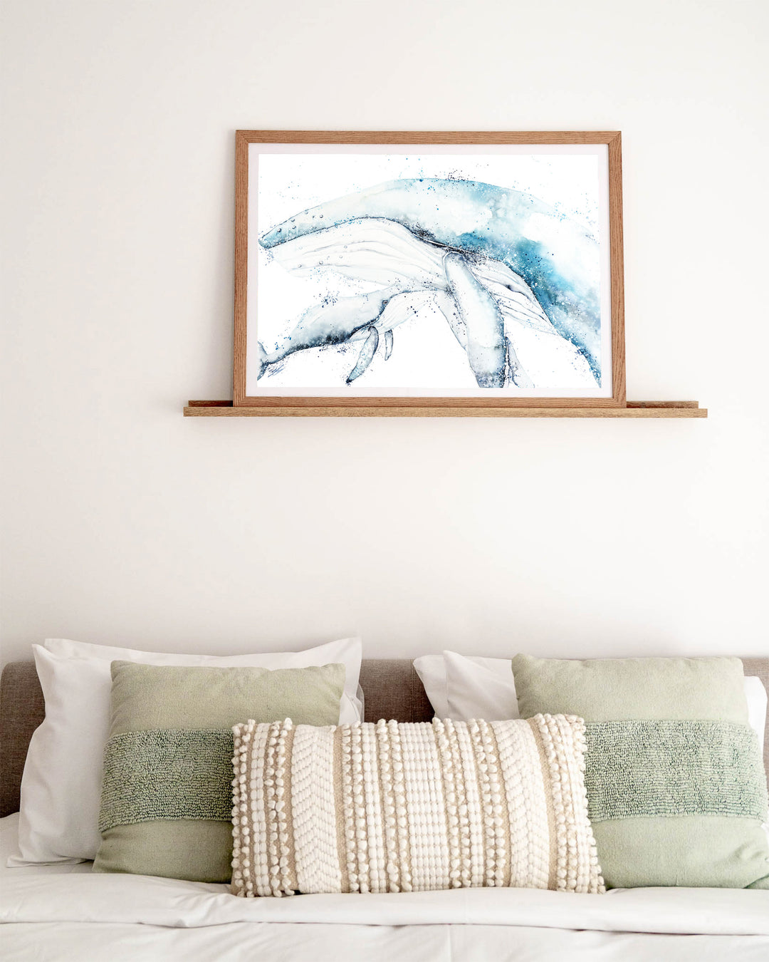 Long Days, Short Years – humpback whale mother and calf, framed paper print in oak frame, styled above a bed