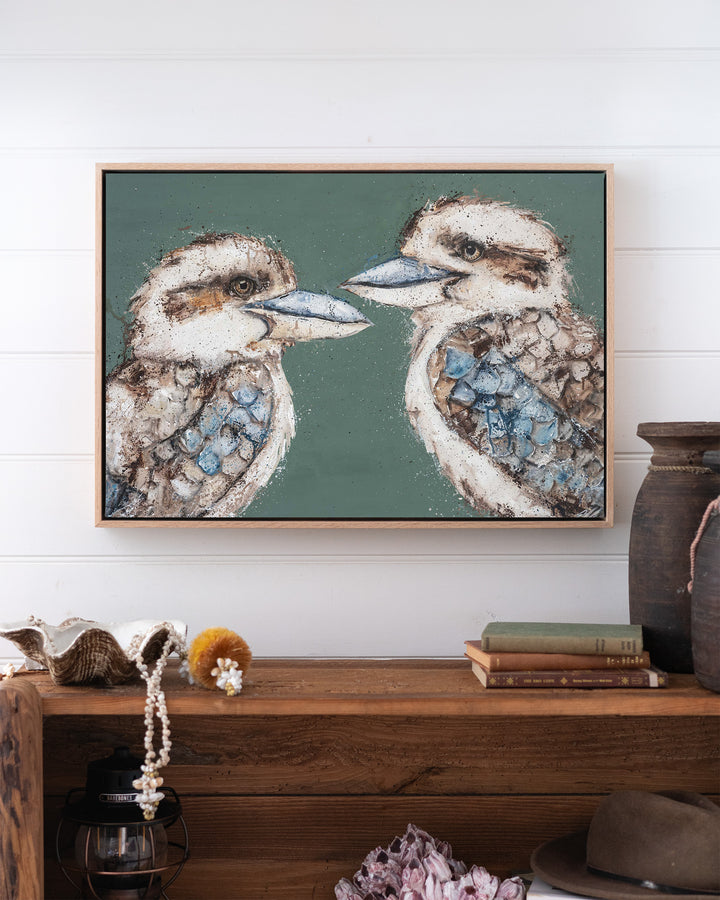 Love Me Now – kookaburras, framed canvas in oak float frame, styled above a timber console