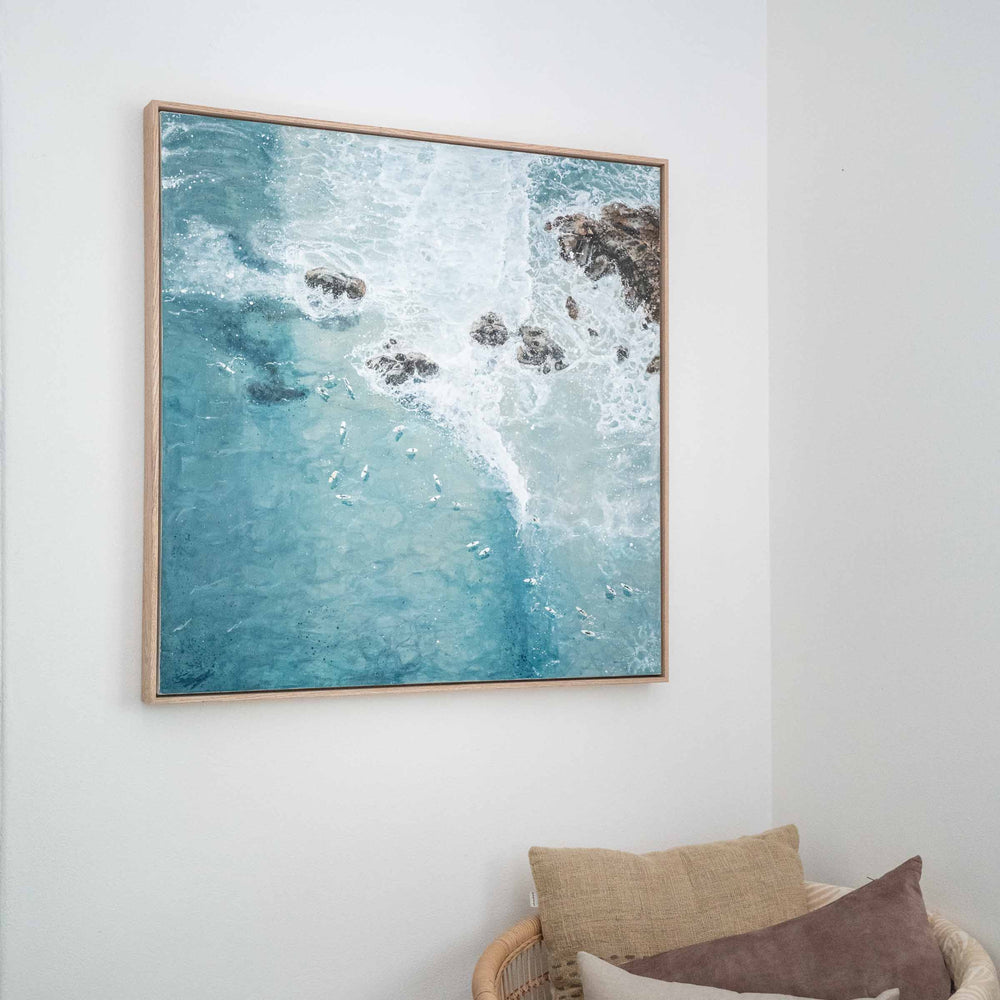 Meet Me at the Pass – coastal surf painting of Byron Bay break with surfers and rocky headland styled in relaxed interior with figure for scale by Stephanie Elizabeth | Original Artwork