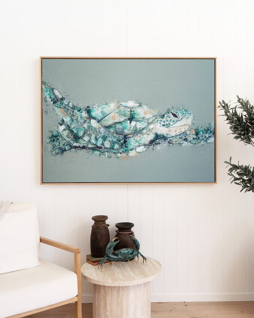 Message in a Bottle green sea turtle fine art print by Stephanie Elizabeth, framed canvas in an oak frame in a living room
