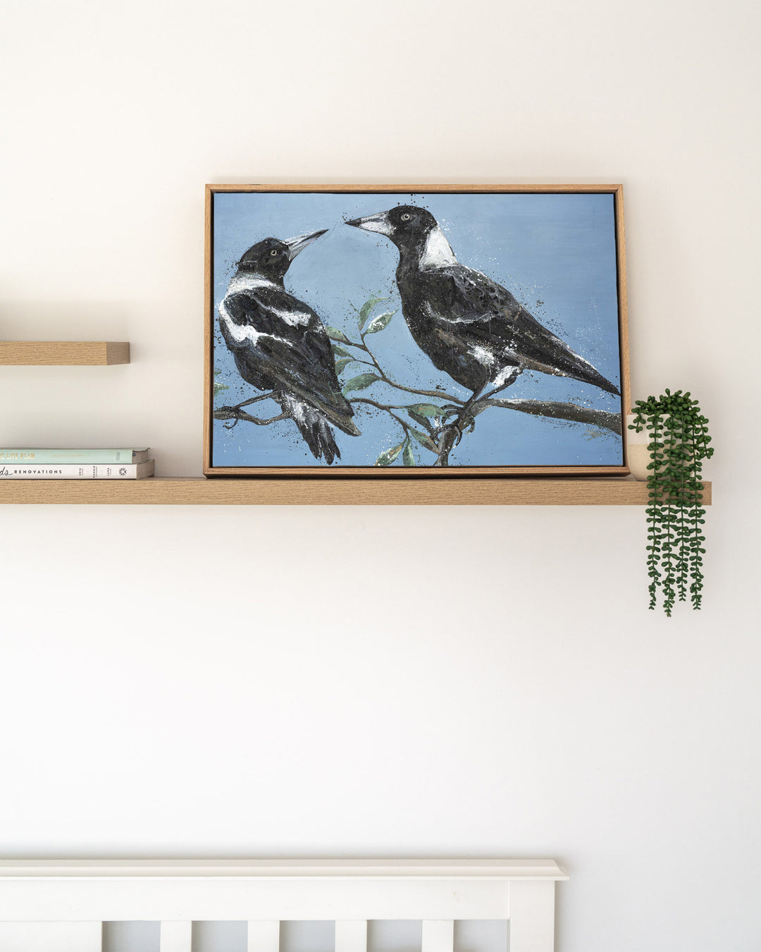Monochrome Muses – magpies, framed canvas in oak float frame, styled on a floating shelf