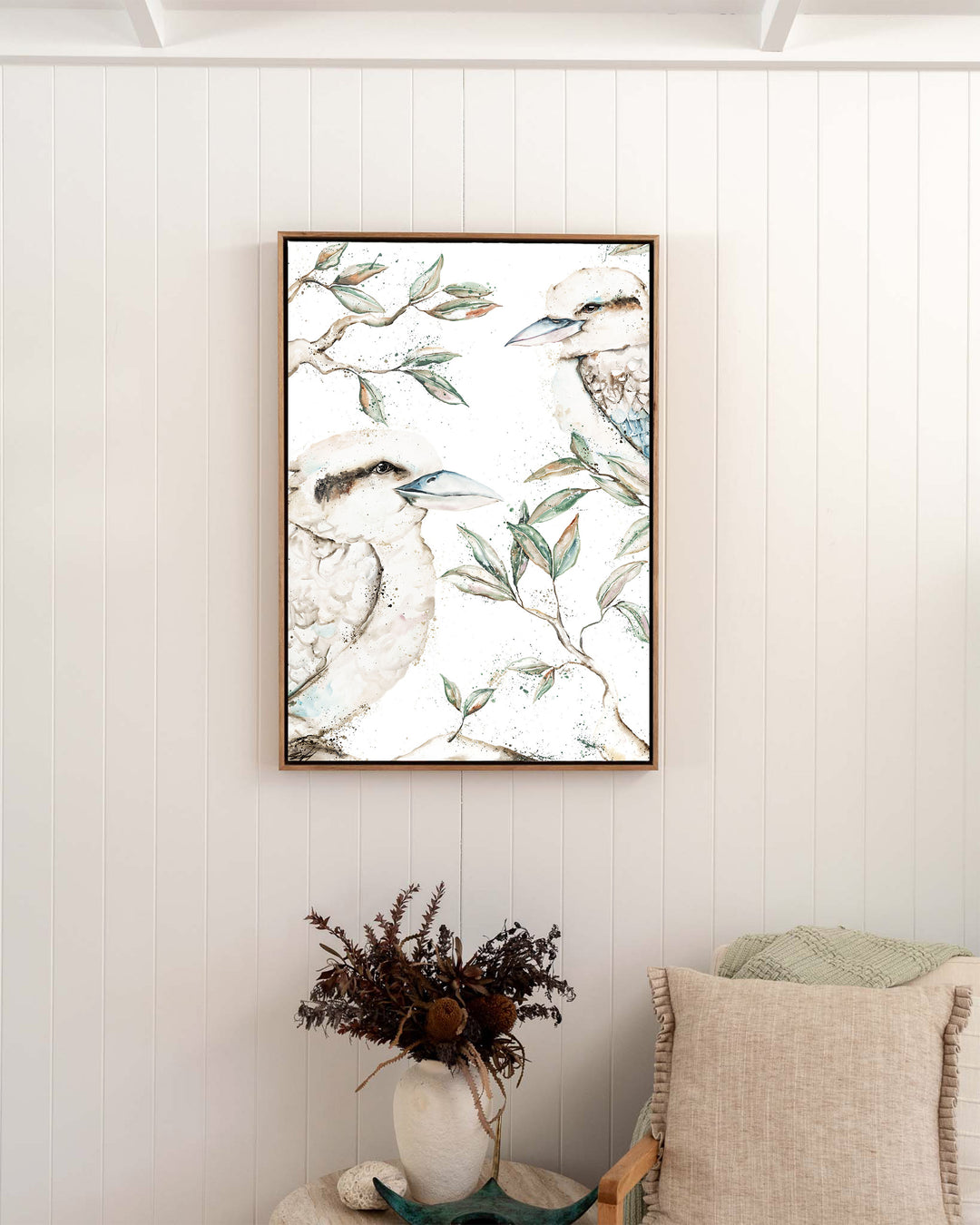 Morning Chatter – kookaburras, framed canvas in oak float frame, styled in a bedroom