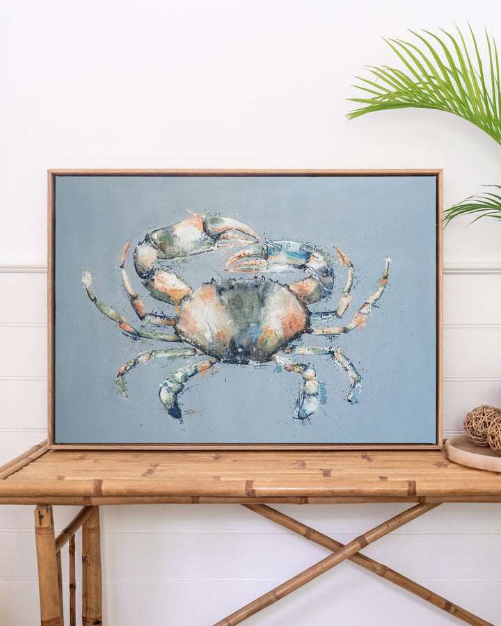 Muddy Days – mud crab, framed canvas in oak float frame, styled on a rattan table