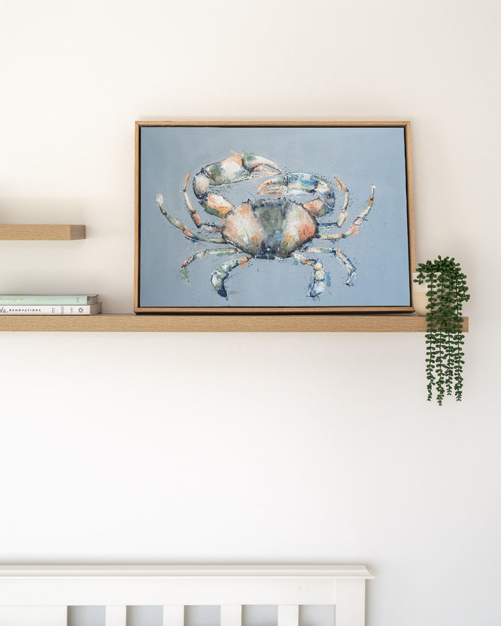 Muddy Days – mud crab, framed canvas in oak float frame, styled on a floating shelf