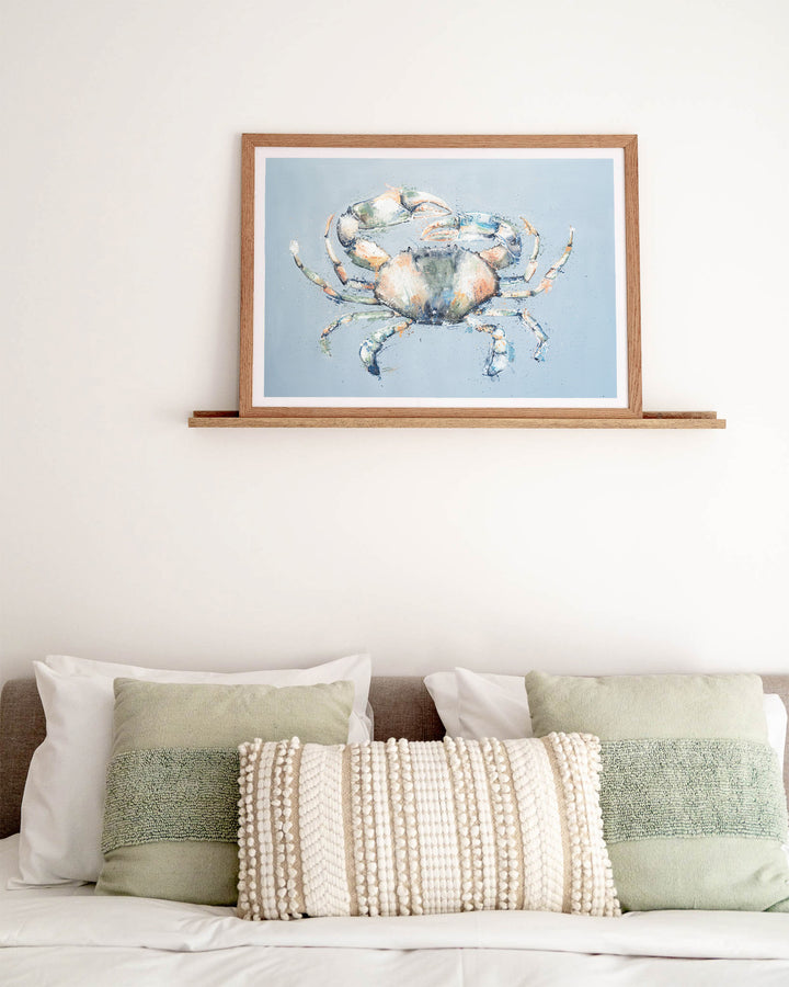 Muddy Days – mud crab, framed paper print in oak frame, styled above a bed