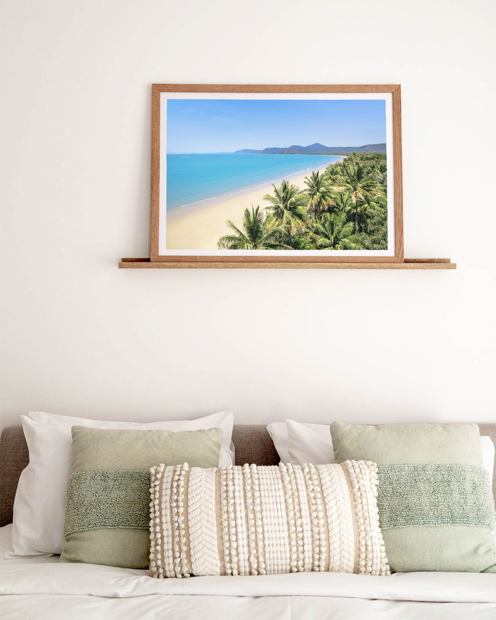 No Place I'd Rather Be – Four Mile Beach, Port Douglas, Aerial Photography by David Lloyd, framed paper print in oak frame, styled in a bedroom setting