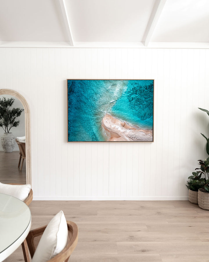 Nothing but Footprints – Ocean Art, Aerial Photography by David Lloyd, framed canvas print in oak float frame, styled in a dining room setting