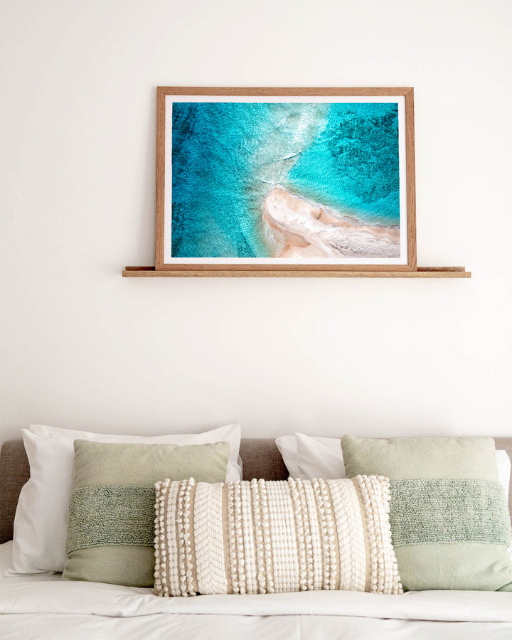 Nothing but Footprints – Ocean Art, Aerial Photography by David Lloyd, framed paper print in oak frame, styled in a bedroom setting