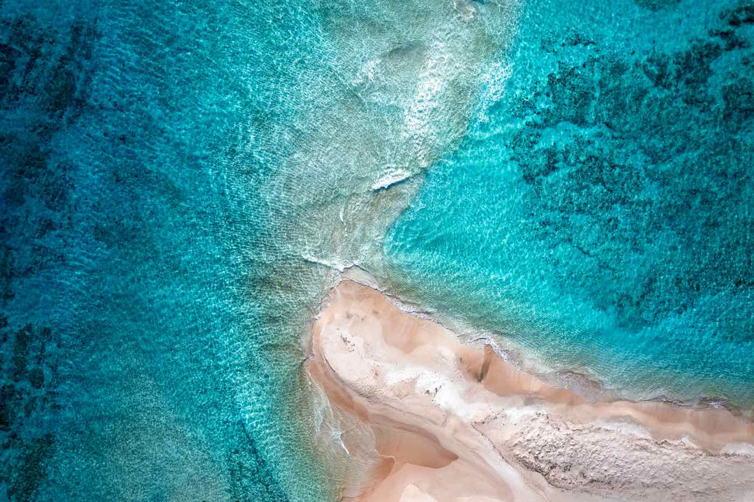 Nothing but Footprints – Aerial view of ocean with sandy beach and footprints in the sand | Unframed Rolled Print