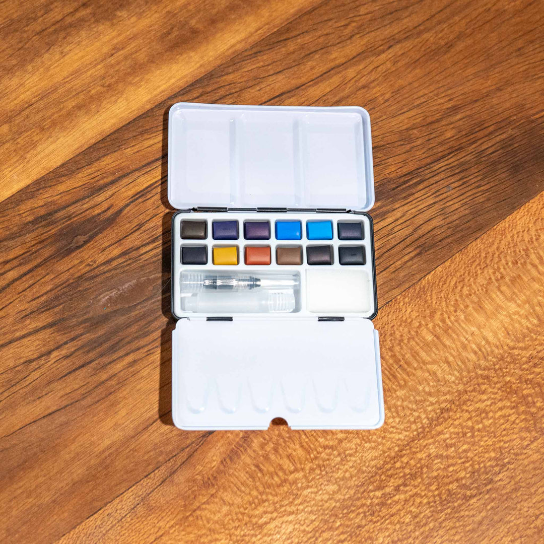 Ocean Watercolour Pocket Set by SEA Gallery with open case showing palette, brush, and blue-teal watercolors.