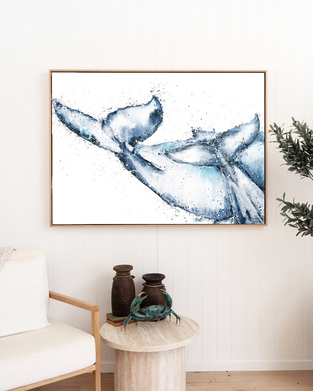 One Tale, Two Tails – whale tails, framed canvas in oak float frame, styled in a living room