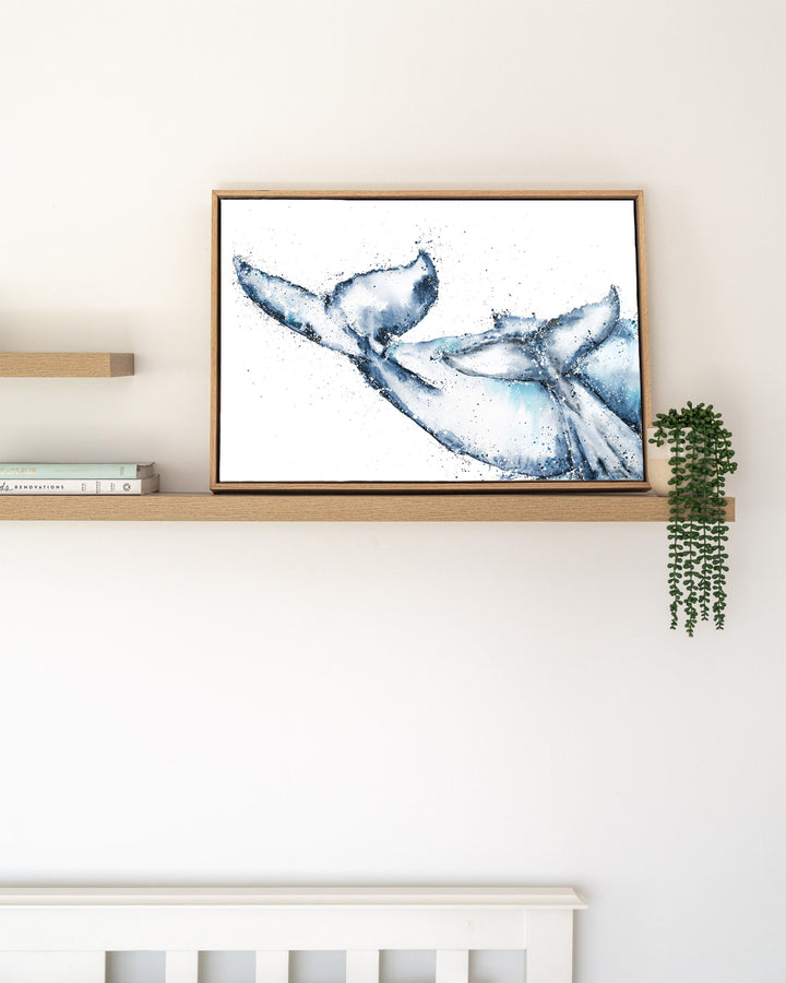 One Tale, Two Tails – whale tails, framed canvas in oak float frame, styled on a floating shelf