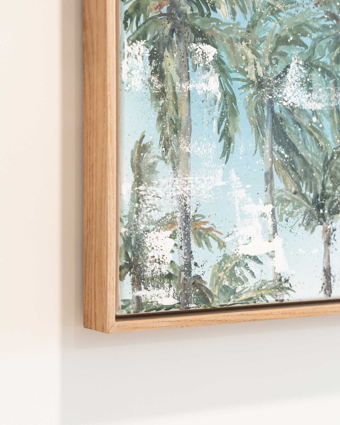 Over Flagstaff“ framed print featuring palm trees under a pale blue sky, displayed on a white wall.