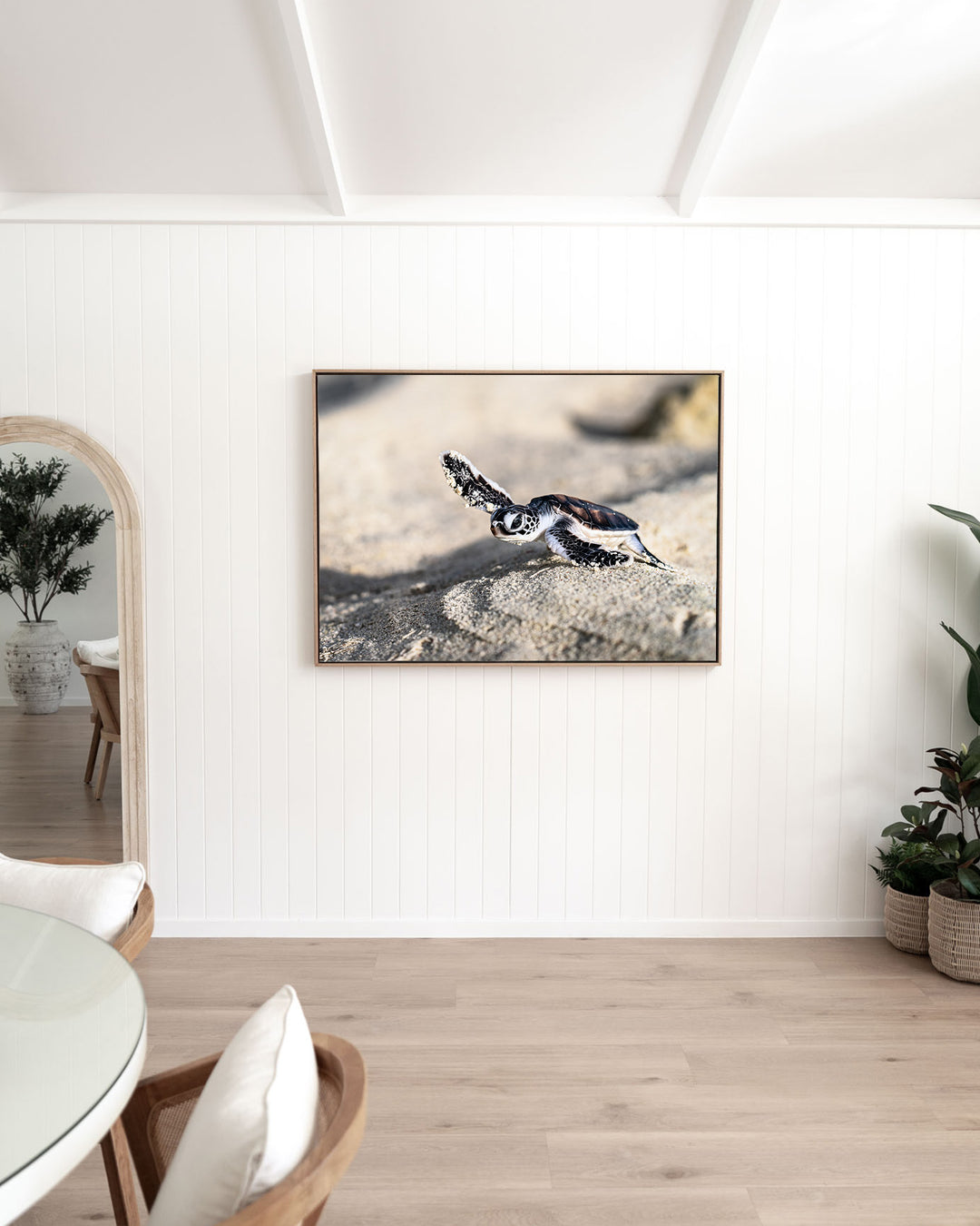 Over the Dunes – Turtle Hatchling, Ocean Photography by David Lloyd, framed canvas print in oak float frame, styled in a dining room setting
