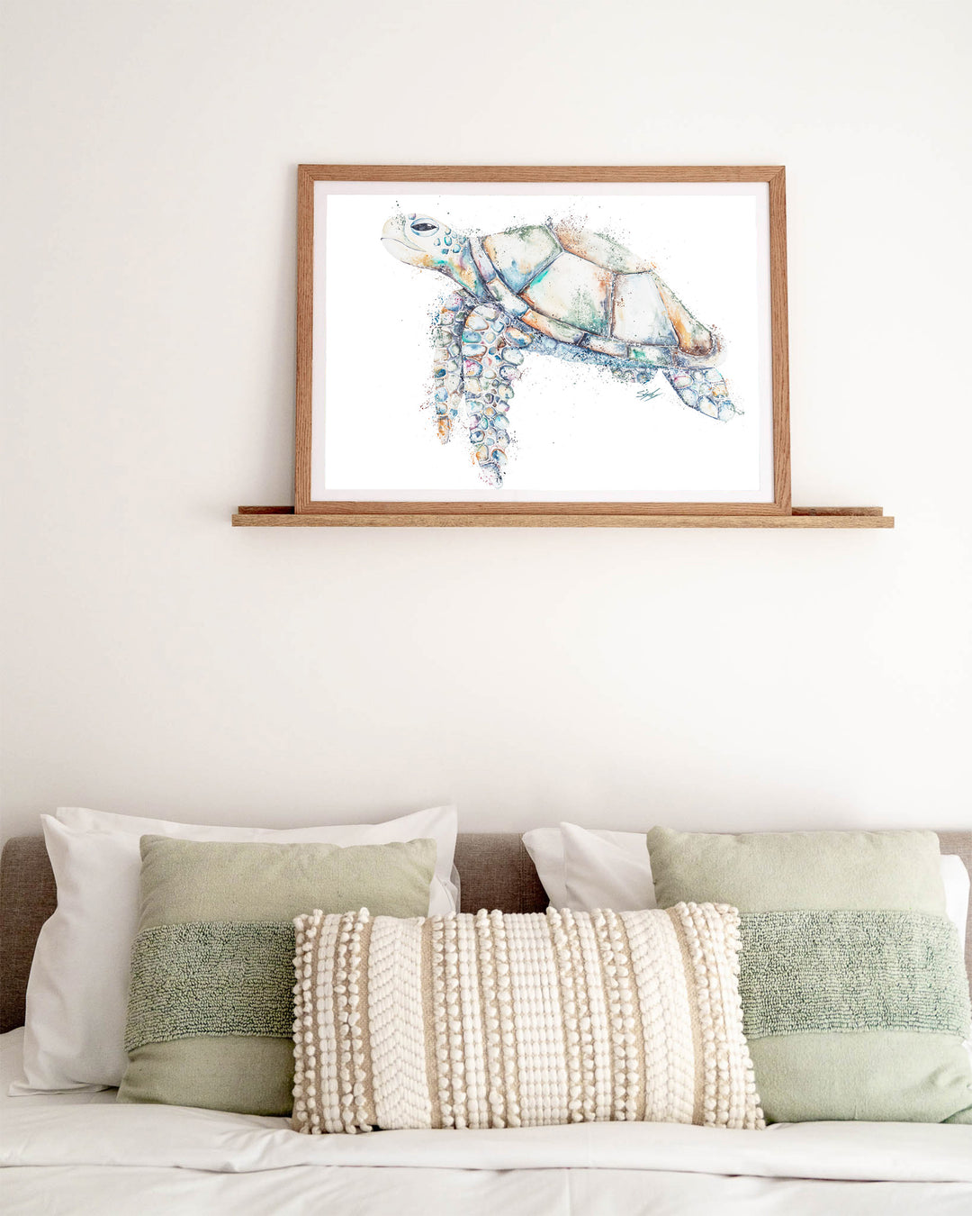 Patchwork – sea turtle, framed paper print in oak frame, styled above a bed