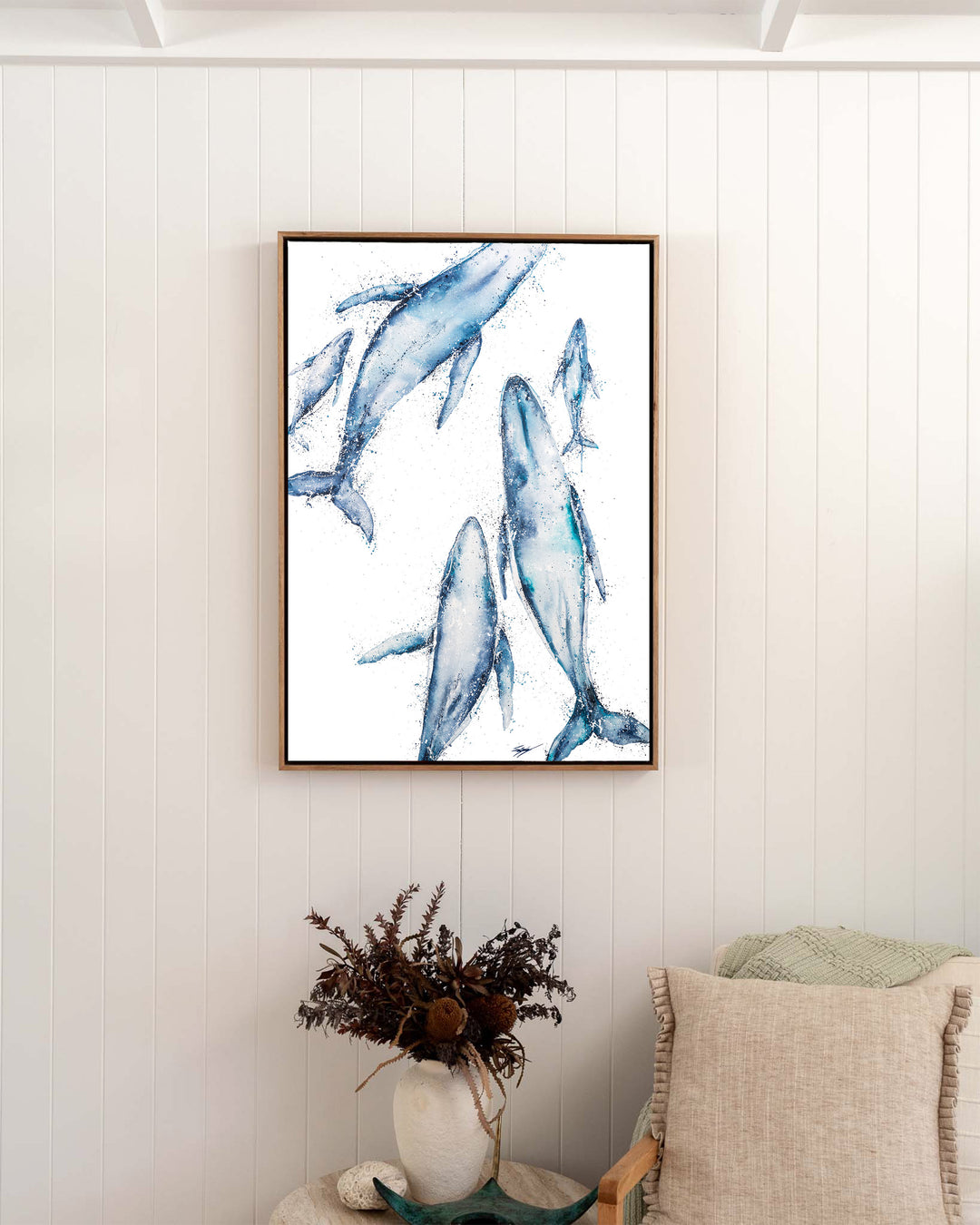 Paving The Way – humpback whales, framed canvas in oak float frame, styled in a bedroom