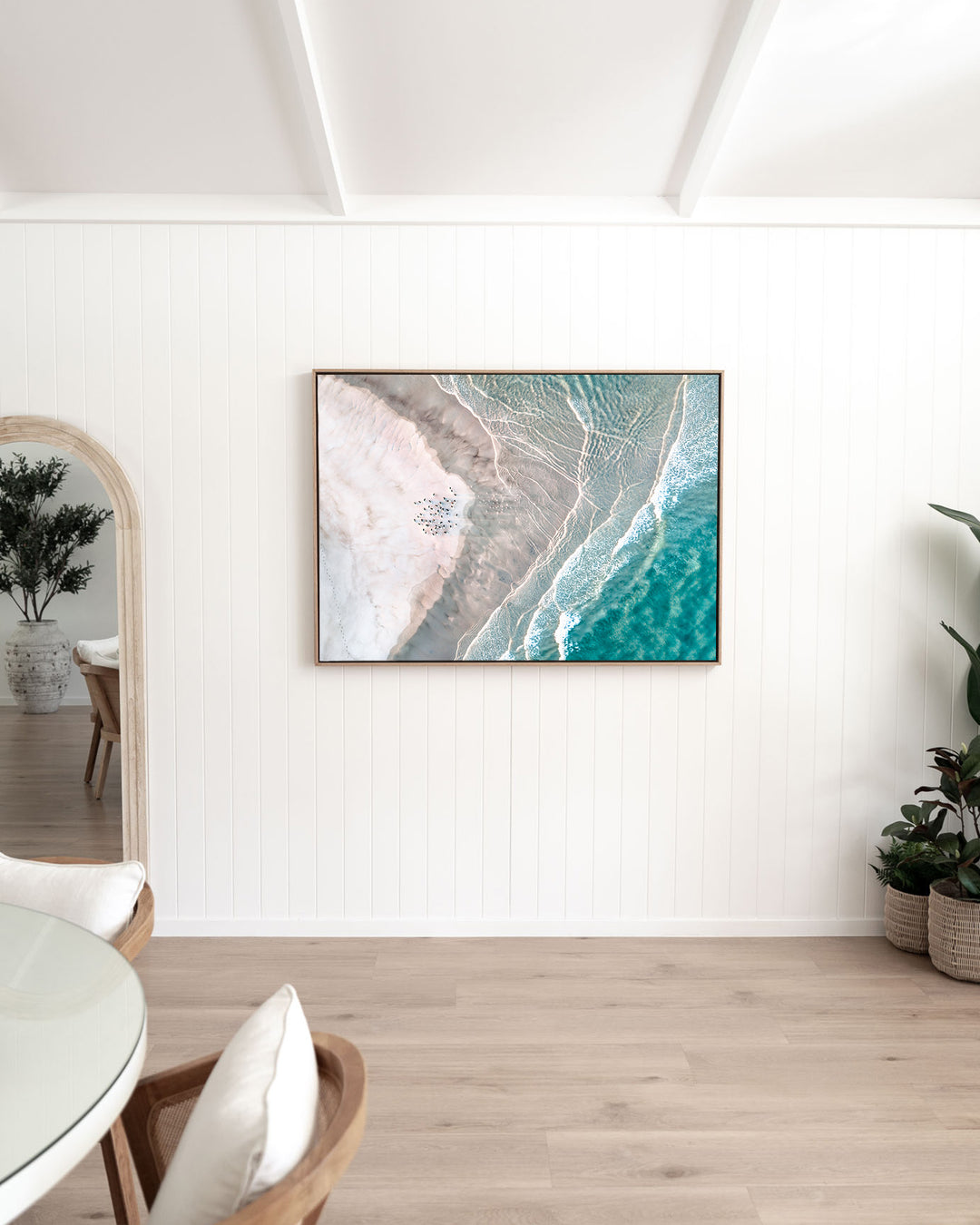 Pearls and Pelicans – Stradbroke Island, Aerial Photography by David Lloyd, framed canvas print in oak float frame, styled in a dining room setting