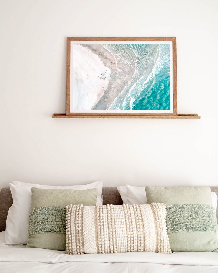 Pearls and Pelicans – Stradbroke Island, Aerial Photography by David Lloyd, framed paper print in oak frame, styled in a bedroom setting