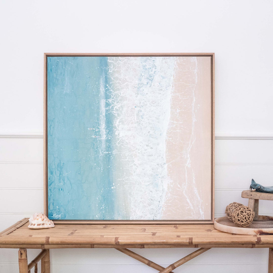 Quiet Shift – aerial coastal artwork featuring split beach and ocean with soft waves and long boats styled in light interior setting | Original Artwork