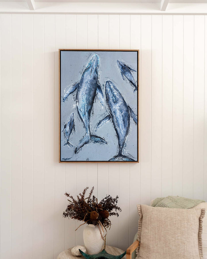 Raise Them on Rhythm and Blues – humpback whales, framed canvas in oak float frame, styled in a bedroom